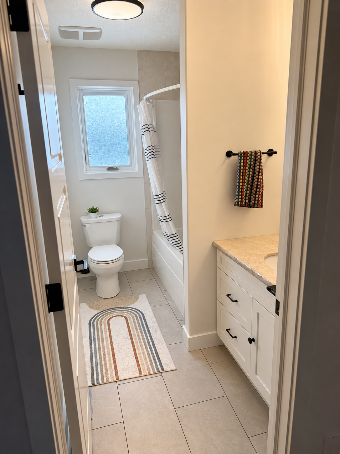 Existing upstairs kids bathroom single sink and swing door