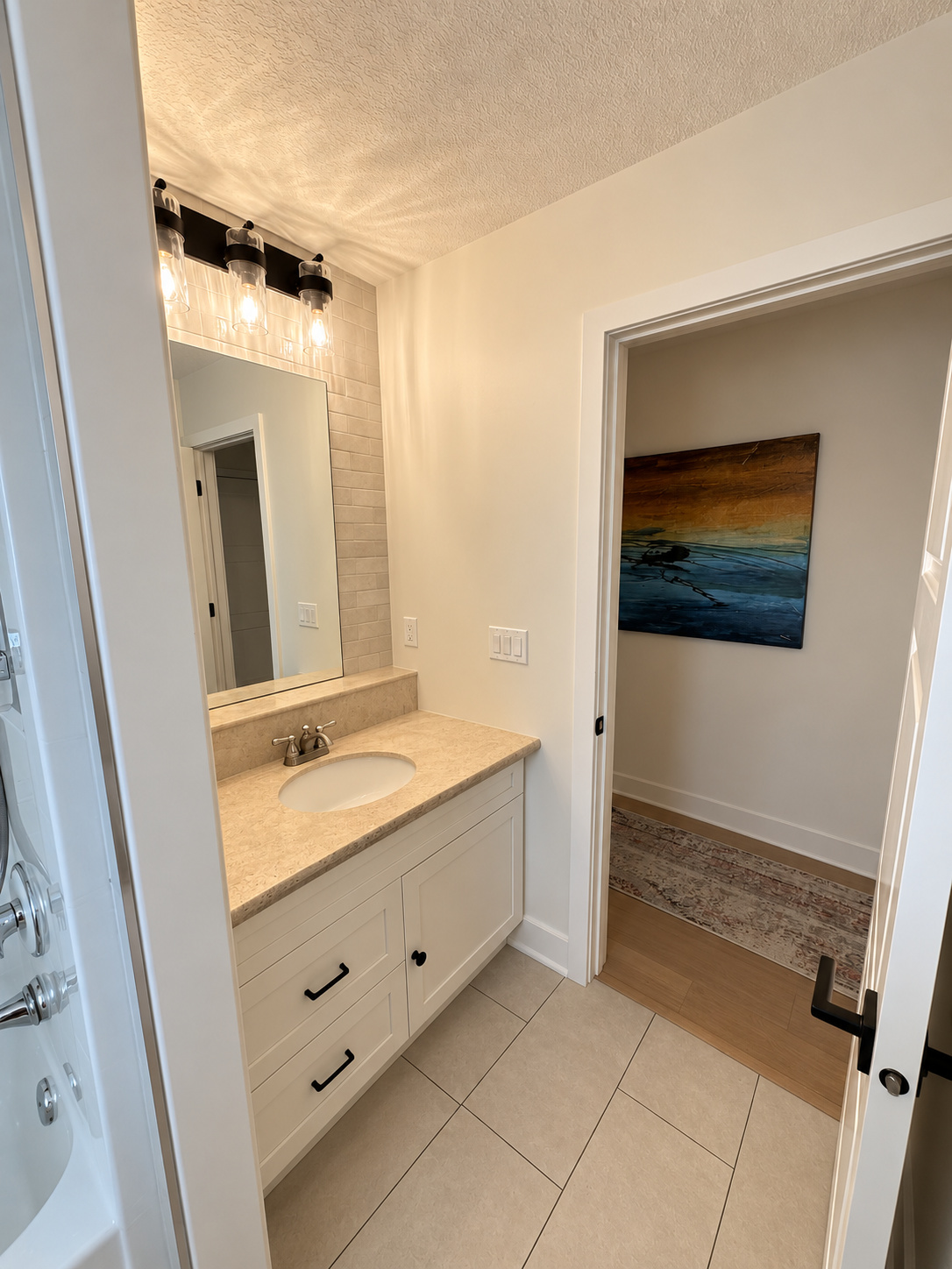 Existing upstairs kids bathroom with single sink tub and swing door